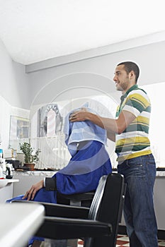Hairdresser Drying Man's Hair With Towel