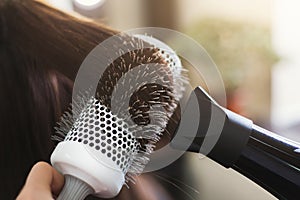 Hairdresser drying woman`s hair in beauty salon