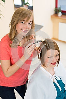 Hairdresser dying hair of client