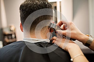 Hairdresser hands trimming customer