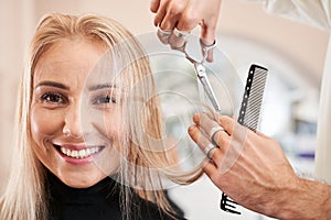 Hairdresser holding a strand of combed hair