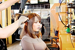 Hairdresser makes a hair dress