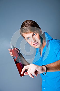 Hairdresser man with hairspray photo