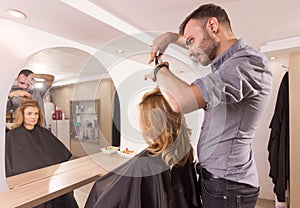 Hairdresser mirror cutting hair sideview