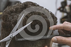 hairdresser professionally performs a haircut