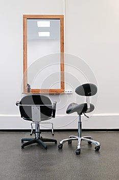 Hairdresser`s chair and mirror ready to receive visitors. The