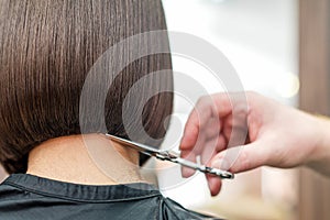 Hairdresser`s hand cuting hair tips