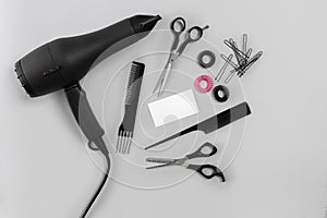 Hairdresser set with various accessories on gray background