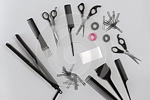 Hairdresser set with various accessories on gray background