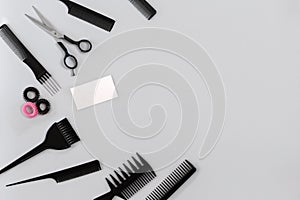 Hairdresser set with various accessories on gray background