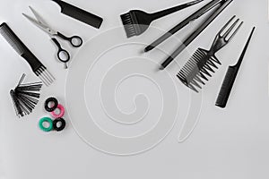 Hairdresser set with various accessories on gray background