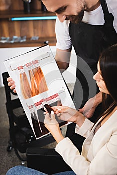 Hairdresser showing hair colors palette to