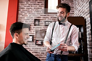 Hairdresser shows customer a quality hair gel