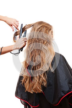 Hairdresser straightening hair