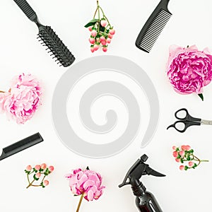Hairdresser styler concept with spray, scissors, combs and peonies flowers on white background