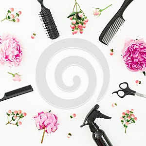 Hairdresser styler frame with spray, scissors, combs and peonies flowers on white background