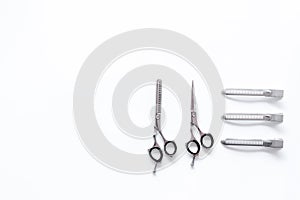 Hairdresser tools in beauty salon. Sciccors and barrette on white background top view copyspace