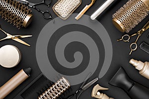 Hairdresser tools on black background with copy space in center