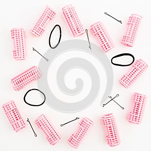 Hairdresser tools - curlers, and hair clips on white background. Beauty composition. Frame with copy space. Flat lay, top view