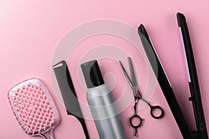 Hairdresser tools on pink background.