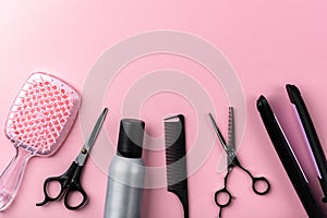 Hairdresser tools on pink background.