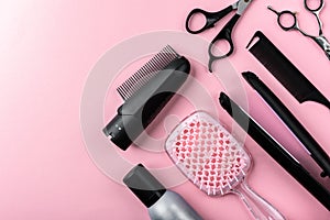 Hairdresser tools on pink background.