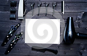 Hairdresser tools on wooden background. Blank card with barber tools flat lay. Top view on wooden table with scissors, comb.