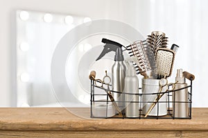 Hairdresser tools on wooden table with blurred beauty salon background