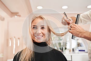 Hairdresser using comb and scissors
