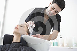 Hairdresser Washing Client's Hair At Parlor