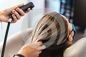 Hairdresser washing the hair of a woman