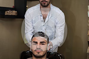Hairdresser Washing Man Head In Barber Shop