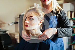 Hairdresser with woman in hairdressing salon.