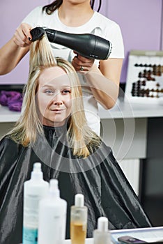 Hairdresser at work. Dryeing hair