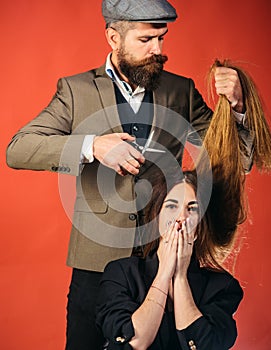 Hairdresser work on female haircut. Gorgeous hair. Woman with long hair on wooden background. Model with curly hairstyle