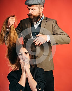 Hairdresser work on female haircut. Gorgeous hair. Woman with long hair on wooden background. Model with curly hairstyle