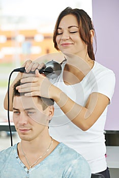 Hairdresser at work making haircut