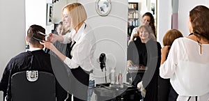 Hairdressers cutting hair in salon