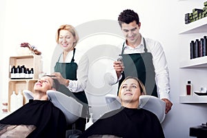 Hairdressers wash client's hair