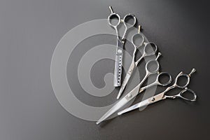 Hairdressing different scissors isolated on black background