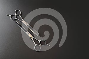 Hairdressing different scissors isolated on black background