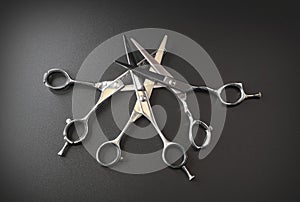 Hairdressing different scissors isolated on black background