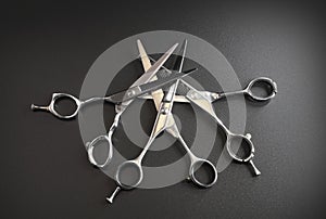 Hairdressing different scissors isolated on black background