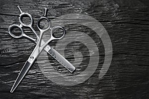 Hairdressing different scissors isolated on black wooden