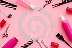 Hairdressing mockup - with brush, spray and sciccors - on pink background top-down frame copy space