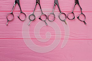 Hairdressing scissors on colorful background.