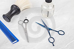 Hairdressing scissors comb and accessories on the white background with copy space