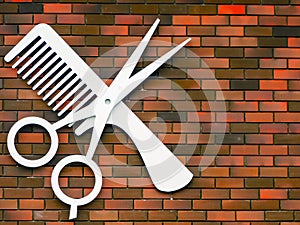 Hairdressing: scissors and comb emblem hanging on a brick wall photo