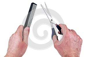 Hairdressing scissors and a comb in the hands