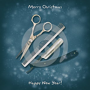 Hairdressing scissors, comb and razor on a dark background. Happy New Year and Merry Christmas. Greeting card for